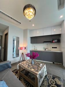 a living room with a table with flowers on it at Luxurystay-supernova in New Delhi
