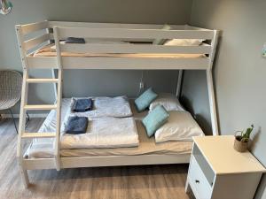 a bunk bed with pillows and a bed in a room at Jerup Bed & Breakfast in Jerup +90 photos