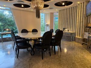 a dining room with a table and chairs at Kowloon Harbourfront Hotel in Hong Kong