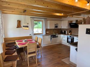 a kitchen with a table and chairs in a room at Alpenchalet Sonnberg in Kalwang