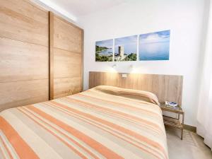 a bedroom with a large bed and a table at Residence Glicini in Finale Ligure