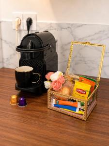 a table with a cup of coffee and a box of stationery at Le Cocon Signature in Château-Thierry