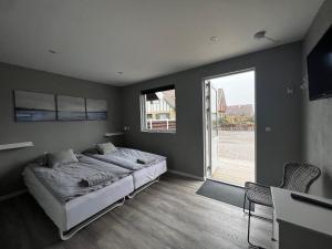 a bedroom with a bed and a large window at Jerup Bed & Breakfast in Jerup