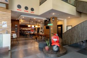 a red scooter sitting in the middle of a lobby at Kalya Hotel Bandung Dago in Bandung