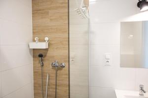 a shower in a bathroom with a glass door at BLOMMA Niechorze in Niechorze +80 photos