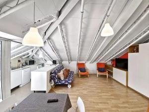 a living room with chairs and a table and a kitchen at Residence Glicini in Finale Ligure