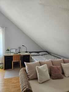 a room with a couch and a desk with a bed at Green Living in Meckenbeuren