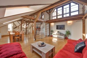 a living room with a red couch and a table at Amazing Charles Bridge Apartment in Prague