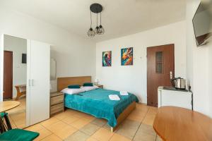 a bedroom with a bed and a table in it at Willa Tina in Karwia