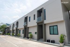 a row of apartment buildings on a street at The Regent Studio Kamala in Kamala Beach