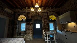 a room with a bed and a kitchen with a table at The Kamaraki Project in Kórthion