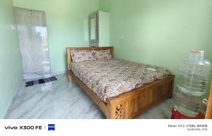a bedroom with a bed and a stack of water bottles at VvM COTTAGE in Thiruchendur