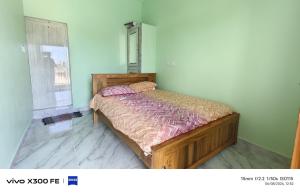 a bedroom with a bed in a room with a window at VvM COTTAGE in Thiruchendur