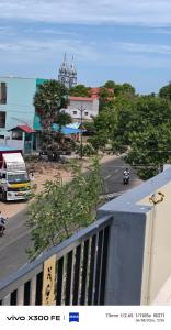a view of a parking lot from a balcony at VvM COTTAGE in Thiruchendur