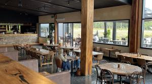 a restaurant with tables and chairs and a bar at Heyscape Denmark in Denmark