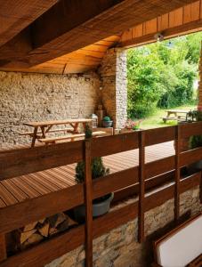 a wooden deck with a view of a garden at Cabane Des Boiseries in Esnans +11 photos