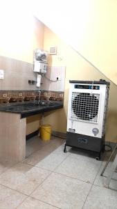 a machine sitting on a table in a kitchen at The Stay Spot in Kharar