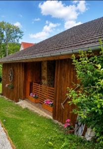 a wooden house with two flower boxes on it at Cabane Des Boiseries in Esnans