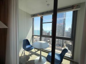 a room with a table and chairs in front of a window at Bona Together In Haeundae Residence in Busan