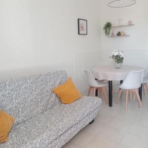 a living room with a couch and a table at La Perla sul Trasimeno in San Feliciano