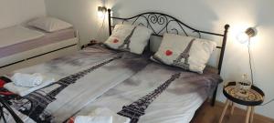 a bedroom with a bed with eiffel tower pillows at Apartment Grapevine in Kornić