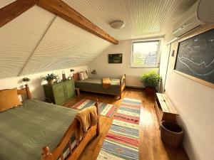 a bedroom with a bed and a table and a chalkboard at Sziget Gyöngye Vendégház in Tahitótfalu