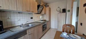 a small kitchen with a sink and a stove at FeWo Christa in Marpingen +15 photos