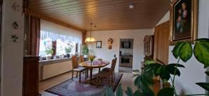 a kitchen and dining room with a table and chairs at FeWo Christa in Marpingen
