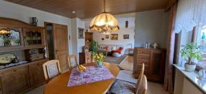 a kitchen with a table and a dining room at FeWo Christa in Marpingen