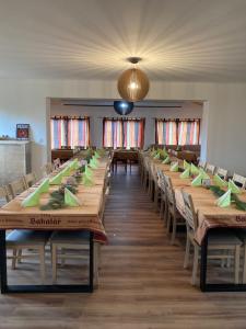 a large room with long tables and chairs at Statek U Dubu in Svojetín