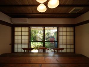 a room with two chairs and a large window at Ukiwa Guest House in Shimoda +23 photos