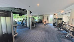 a gym with treadmills and elliptical machines at Tambuli Seaside Living Pad seaview in Maribago