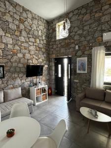 a large living room with a stone wall at Casa Petra Astypalea in Astypalaia