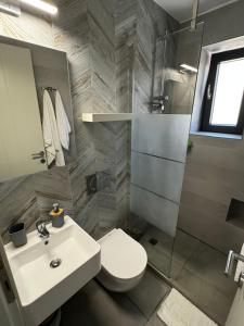 a bathroom with a sink and a toilet and a shower at Casa Petra Astypalea in Astypalaia +24 photos