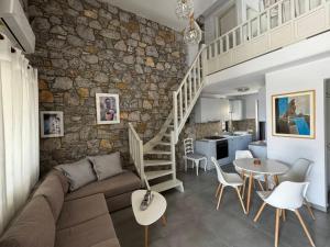 a living room with a couch and a stone wall at Casa Petra Astypalea in Astypalaia