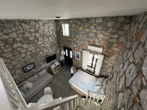 an overhead view of a living room with a stone wall at Casa Petra Astypalea in Astypalaia
