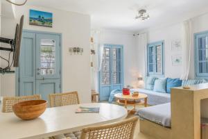 a living room with a table and a couch at Beachfront Ios Villa in Ios Chora