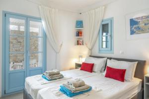 a bedroom with a bed with towels on it at Beachfront Ios Villa in Ios Chora