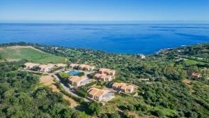 an aerial view of a house on a hill next to the water at Casa Margarita in Tertenìa