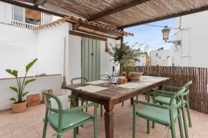 a wooden table and chairs on a patio at Casa Terraza in La Herradura