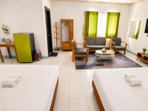 a room with two beds and a living room at Allisa Resort Hotel in Anyer +139 photos
