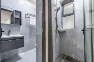 a bathroom with a shower and a sink at Kindaruma Homes Apartments in Nairobi
