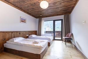 a hotel room with two beds and a window at Lasiim in Mestia