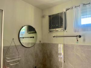 a bathroom with a mirror and a window at Cabin Inn by Batu Pineus in Pengalongan