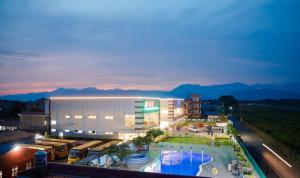 a large building with a pool in front of it at Chitwan Grand Regency in Bharatpur