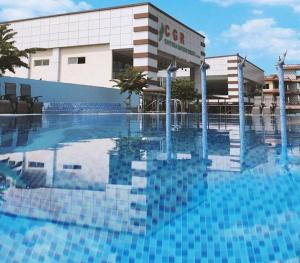 a large swimming pool in front of a building at Chitwan Grand Regency in Bharatpur