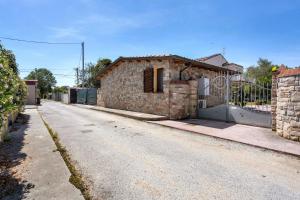 an empty street with a brick building with a gate at I Bibi Vacation Home in Viareggio