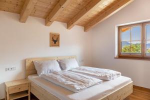 a bedroom with a bed and a window at Haus Stoabock in Wallgau