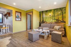 a living room with a couch and a table at Ferienhaus Cajo in Dahmen