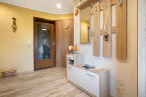 a hallway with a door and a counter with flowers on it at Ferienhaus Cajo in Dahmen +35 photos